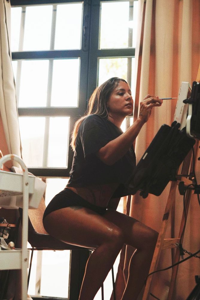 Gigi painting at the easel