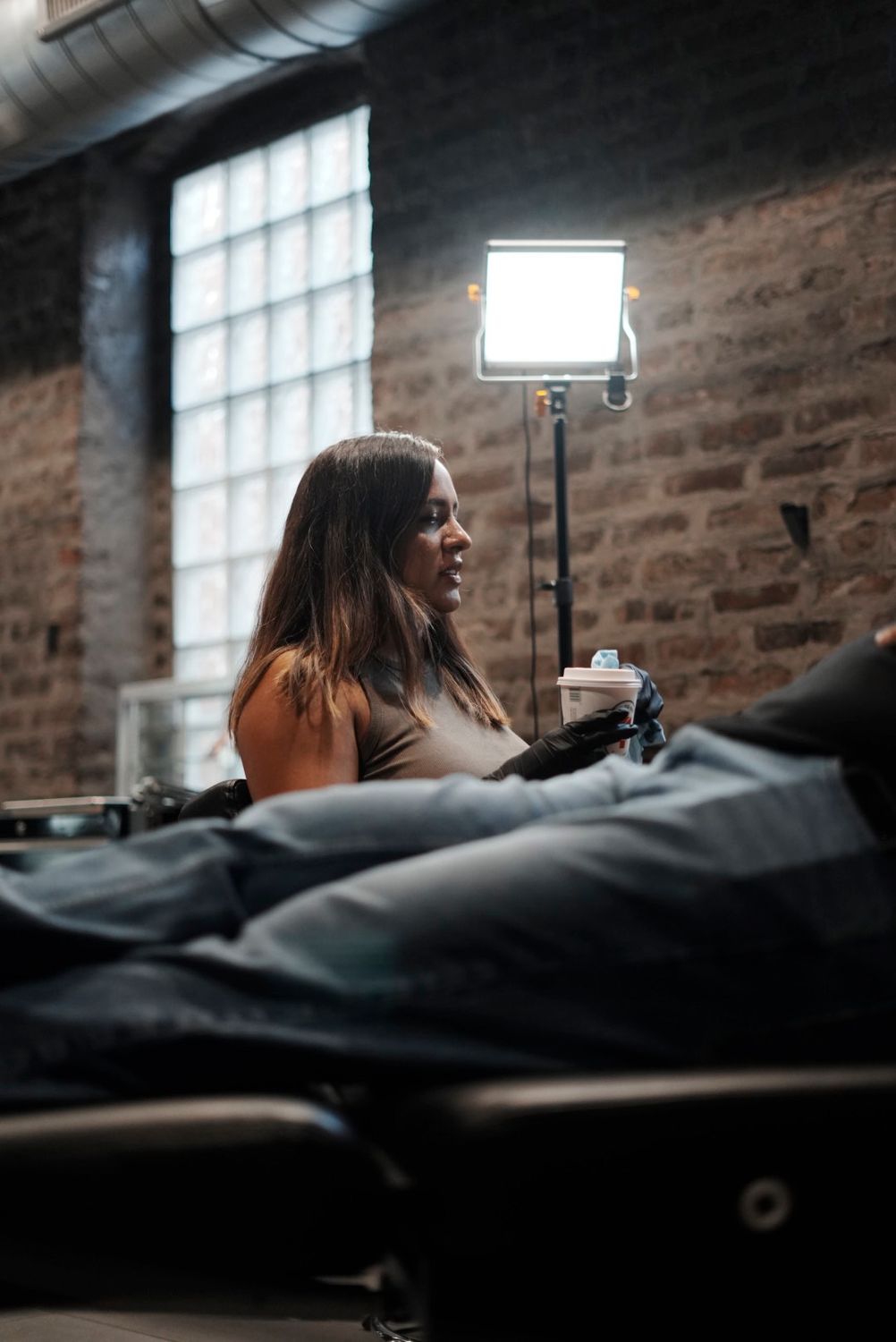 Gigi tattooing a client